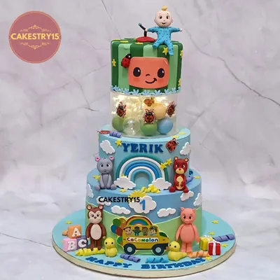 A spectacular three-tier Cocomelon cake for a first birthday. This 5kg choco-vanilla creation features a light-up spacer, fondant characters, and a vibrant, playful design.