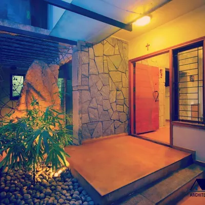 The entrance to a private residence, designed to be a tranquil transition from the outside world. I used natural stone, warm lighting, and integrated planters to create a welcoming and organic entryway.