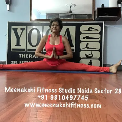 The full front split, or Samakonasana, with hands in prayer. This pose is the result of patient practice, focusing on opening the hips and building strength.