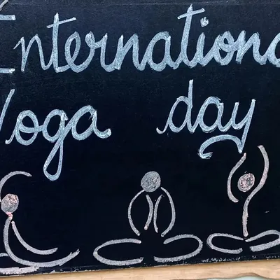A chalkboard sign for International Yoga Day. I believe in introducing children to the benefits of yoga early on, focusing on playful poses and mindful breathing.