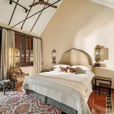 Welcome to Ambara Mana, a 73-year-old Kerala heritage cottage. This spacious room features a high-vaulted ceiling, traditional wooden walls, and elegant furnishings, creating a naturally cool and serene retreat for our guests.