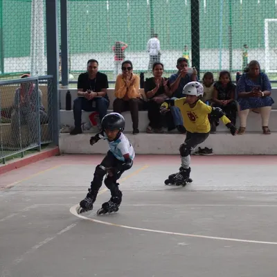 Two of our young racers battling it out on the rink while parents cheer them on. These friendly competitions are a fantastic way for kids to learn sportsmanship and enjoy a little healthy competition among friends.