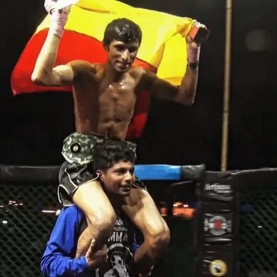 The moment of victory. Our fighter Sumanth is carried on the shoulders of his coach after a knockout win at Art of Combat, Goa. This is the culmination of a brutal fight camp and a testament to the bond between coach and fighter.