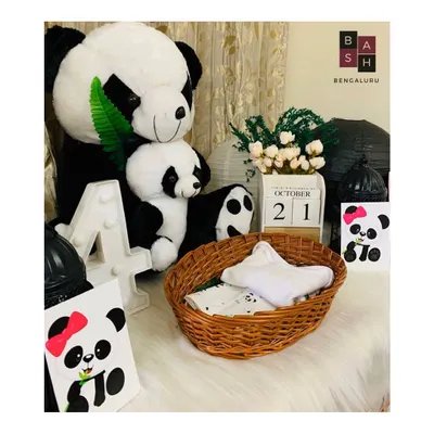 A detailed view of a panda themed photoshoot setup for a 4 month milestone. This package includes plush pandas, a light up number '4', and a decorative calendar block to mark the special date.