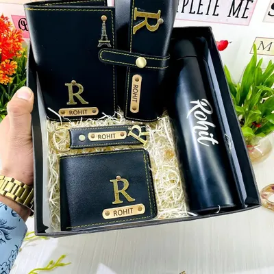 A closer look at the premium men's gift hamper, showcasing the personalized vegan leather wallet, passport cover, sunglass case, and keychain. Each item is customized with a name and initial.