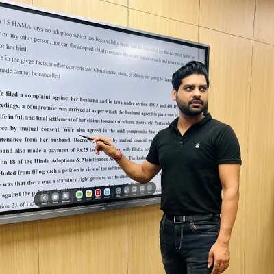 In the classroom, explaining the nuances of a case related to the Hindu Adoptions & Maintenance Act. My goal is to make complex legal provisions easy to understand for aspiring lawyers and judges.