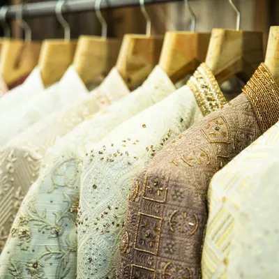 A rack of my creations, showcasing a variety of fabrics, colors, and intricate embroidery. Each piece is crafted to perfection, waiting to become part of a modern man's story.