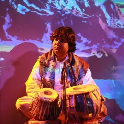 A portrait taken during a performance with a beautiful, artistic projection in the background. The quote reflects my belief that music's purpose is to bring happiness.
