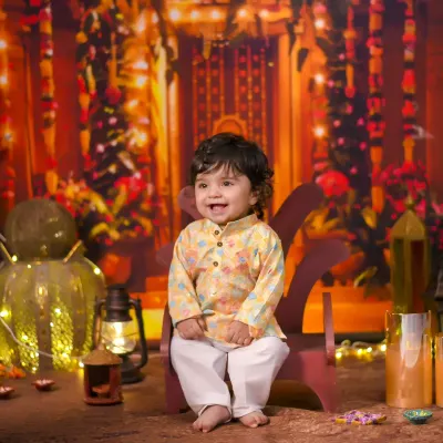 Celebrating a baby's first Diwali is a truly special milestone. I created this warm, festive backdrop with lights and traditional decor to capture the magic of the holiday and the joy of this little one.