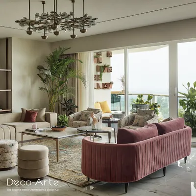 This living room is a voyage of design discovery, featuring a curved pink velvet sofa and a modern chandelier. The space is designed to tell a story, with every detail speaking volumes about refined taste.