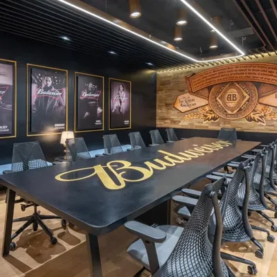 The Budweiser boardroom, where brand identity meets sophisticated design. We created a custom table logo and a hand-painted wall mural that tells the brand's story, transforming a standard meeting space into a powerful statement of corporate culture.