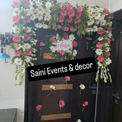 I created this custom floral arch to welcome home a newborn baby named Aadya. It is made with fresh pink and white gerberas and fragrant rajnigandha, designed to fit perfectly around the family's front door.