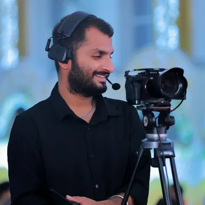 A candid shot of me at work, operating a camera with a headset on a professional set. This shows my experience and focus as a Director of Photography during a shoot.