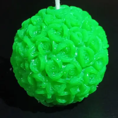 A close-up of my green rose ball candle, showing the detailed petals carved from wax. This spherical candle is a unique decorative object that looks beautiful from every angle.
