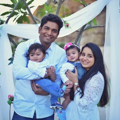 I love capturing families outdoors where kids can be themselves. This beautiful family with their twin girls was all smiles during their natural light session. The coordinated white and denim outfits look perfect against the greenery.