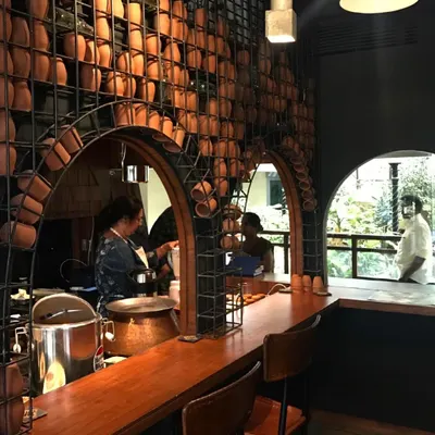 For this restaurant, I designed a feature wall using terracotta pots held within a custom rebar framework. It serves as a rustic and artistic backdrop for the open kitchen and bar area.