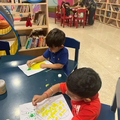 Our toddlers program is in full swing with some fruity fun. Here, the children are enjoying a painting session, creating their own colorful pineapples. This activity is great for color recognition and hand eye coordination.