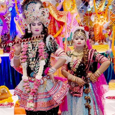 Capturing a vibrant cultural performance with two artists in elaborate traditional costumes representing Radha and Krishna. We are experienced in covering religious and cultural events.