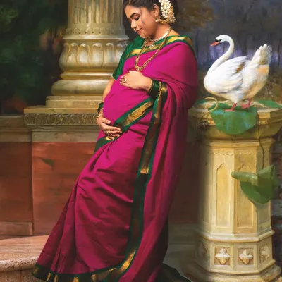 A maternity portrait reimagined from a classic Raja Varma painting. The pose is carefully adapted to gracefully feature the baby bump, blending classical art with the personal story of motherhood.