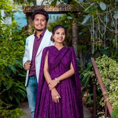 A handsome groom-to-be in a stylish purple shirt and white blazer for his pre-wedding shoot.