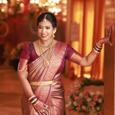 A perfectly draped Kanjeevaram silk saree is the epitome of grace. As part of my service, I ensure the pleats are immaculate and the drape is secure, allowing the client to move with confidence and elegance.