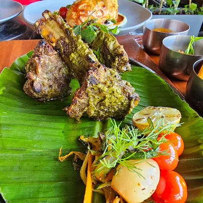 Grilled lamb chops on a banana leaf. This is proof that you can eat delicious, high-protein meals that feel like a treat while still working towards your goals.