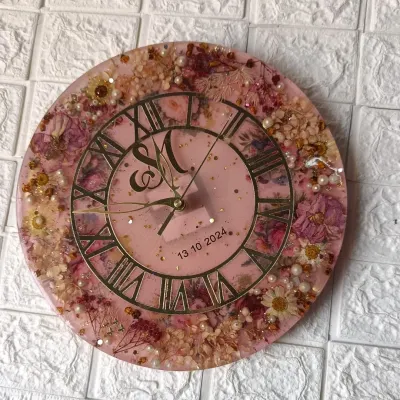 This 12-inch wall clock was made with a client's varmala flowers. I added extra flowers to create this full, beautiful design on a soft pink base with a classic Roman numeral dial.