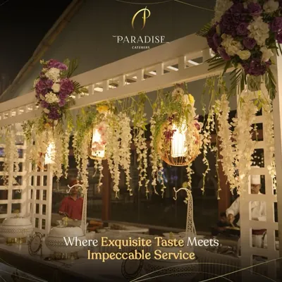 Our catering service goes beyond food; we create an experience. This elegant buffet station, adorned with cascading flowers and beautiful lighting, reflects our philosophy of combining great taste with impeccable presentation.