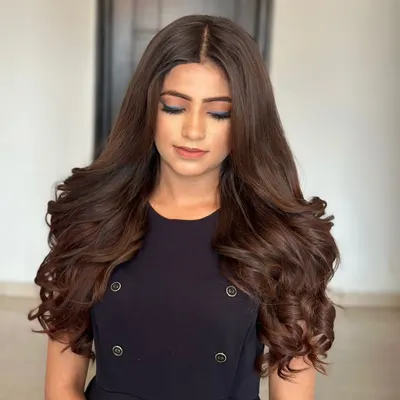 This chic, open hairstyle is all about volume. I used my custom-colored human hair extensions to create these beautiful, full-bodied curls that blend perfectly with her natural hair.