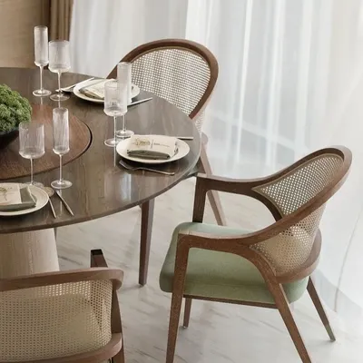 A perfect example of classic elegance, these dining chairs feature a beautiful teak wood frame with a woven rattan back. The soft green velvet seat adds a touch of color and comfort, ideal for long dinners.