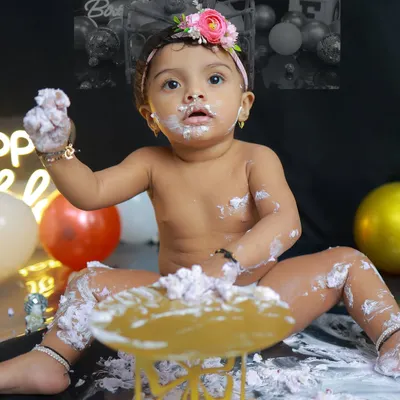 The perfect cake smash moment. This little one is having the time of her life, and her expression of pure, frosting-covered joy is what these sessions are all about.
