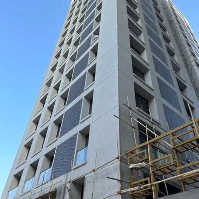 A high-rise project in progress, featuring panels of our dark metal cladding. This shows our capability to execute large-scale facade installations that give a modern, industrial look to any building.