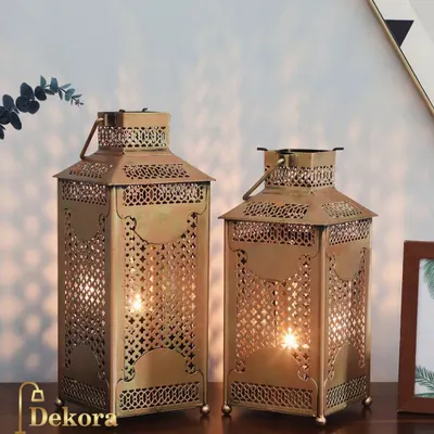 These Moroccan-style metal lanterns feature intricate latticework that casts beautiful, complex shadows when lit. Available in two sizes, they are perfect for adding an exotic and warm ambiance to a patio or living room.
