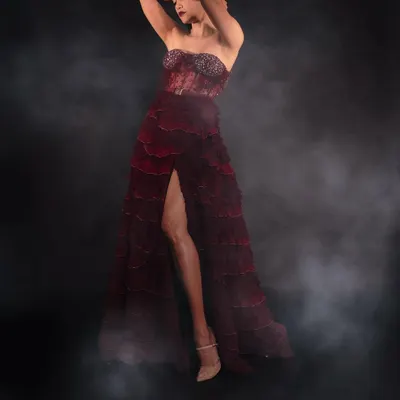 Full-length glamour shot of Aaditi Pohankar. This look is all about drama, with a bold red lip, sculpted cheeks, and a smoky eye, paired with a stunning tiered red gown. Perfect for making a statement on the red carpet.