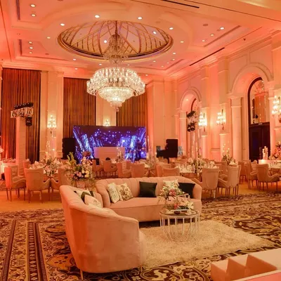 A wide view of this grand ballroom, which I transformed for a ring ceremony using a palette of blush pink, soft lighting, and elegant floral arrangements.