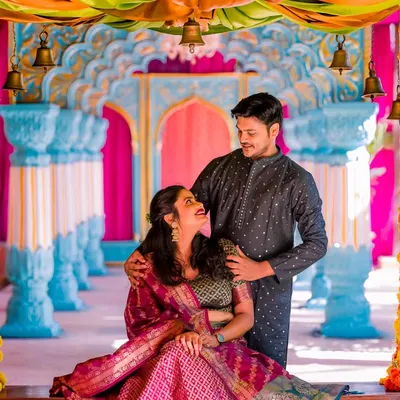 A candid, loving gaze on a decorated swing. The vibrant colors and traditional attire make this a joyful and beautiful pre-wedding portrait.