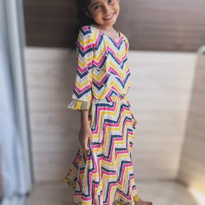 A burst of color and playful chevron prints. This vibrant dress is made from the softest cotton, perfect for a little one with a personality just as vibrant. The tassel detailing adds a fun, twirl-worthy touch.