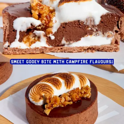 Our S'mores Tart is pure indulgence. It features a crisp chocolate shell, molten dark chocolate ganache, hazelnut praline, and a toasted marshmallow crown.
