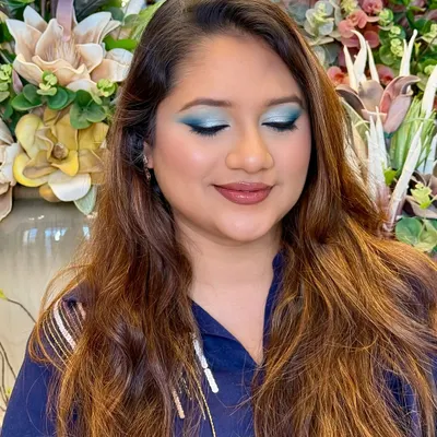 A bold pop of teal with soft glam skin. This look is all about confidence, with a clean blend, a luminous base, and an eye-catching statement shadow.
