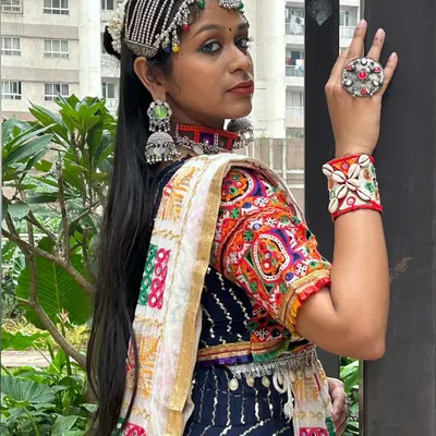 A perfect example of layering accessories. This look features an elaborate matha patti, a bold choker, statement jhumkas, a large ring, and an embroidered cuff.