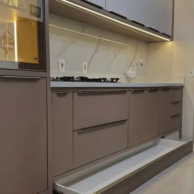 This is a plinth drawer, or toe-kick drawer, I installed. It uses the often-wasted space at the very bottom of the cabinets, perfect for storing baking trays, platters, or extra cleaning cloths.
