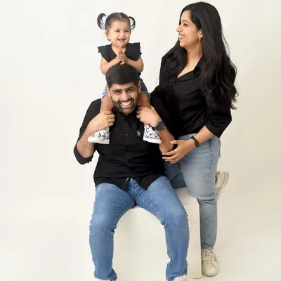 A fun and candid family moment. The little girl sits on her dad's shoulders, and the whole family is laughing. This is the kind of joyful, relaxed memory I love to capture.