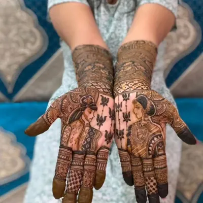 My absolute favorite thing to do is create portrait mehendi. This design captures the bride and groom, creating a piece of art that tells their unique love story.