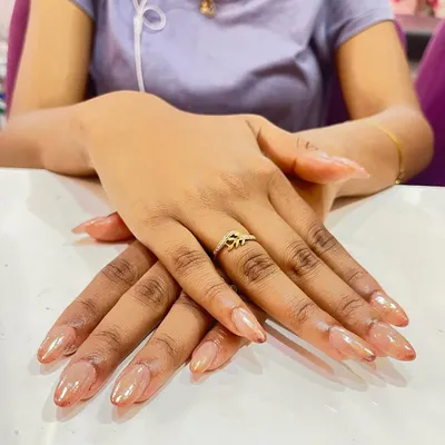 A beautiful example of ombre chrome nails. The color subtly shifts from a light, pearly base to a soft nude tip, creating a seamless and glowing effect.