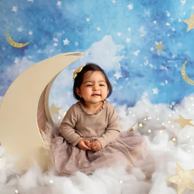 Even the cutest babies have their teary moments, and I think they are just as important to capture. This little one on the moon prop is adorable, even with a sad face.