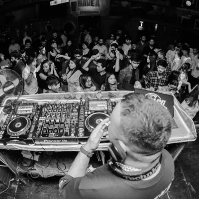 A fisheye view from the DJ console at Nuts & Brew in Guwahati. This shot puts you right in my shoes, looking out at a packed club ready for a banger of a night.