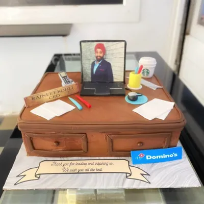 This farewell cake for the CEO of Domino's is a prime example of my detailed sculpting work. The entire office desk scene, including the laptop, papers, and even a miniature Starbucks cup, is handcrafted and edible.