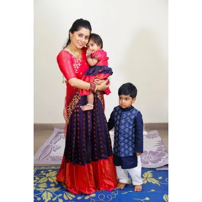 For this family, I designed a matching red and blue silk lehenga set for the mother and daughter. To complete the family look, I created a coordinated brocade kurta for the son, using the same color palette to tie all the outfits together beautifully.