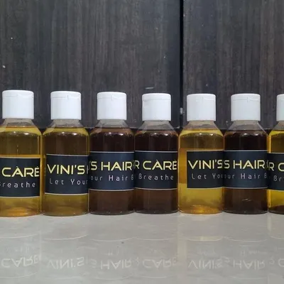 A lineup of freshly prepared customized hair oils, each with a unique blend of herbs for different hair concerns. You can see the variation in color based on the ingredients.