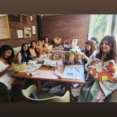 A group of lovely ladies enjoying a creative session, painting and decorating straw bags at a restaurant. I can set up an art party at any venue you choose.